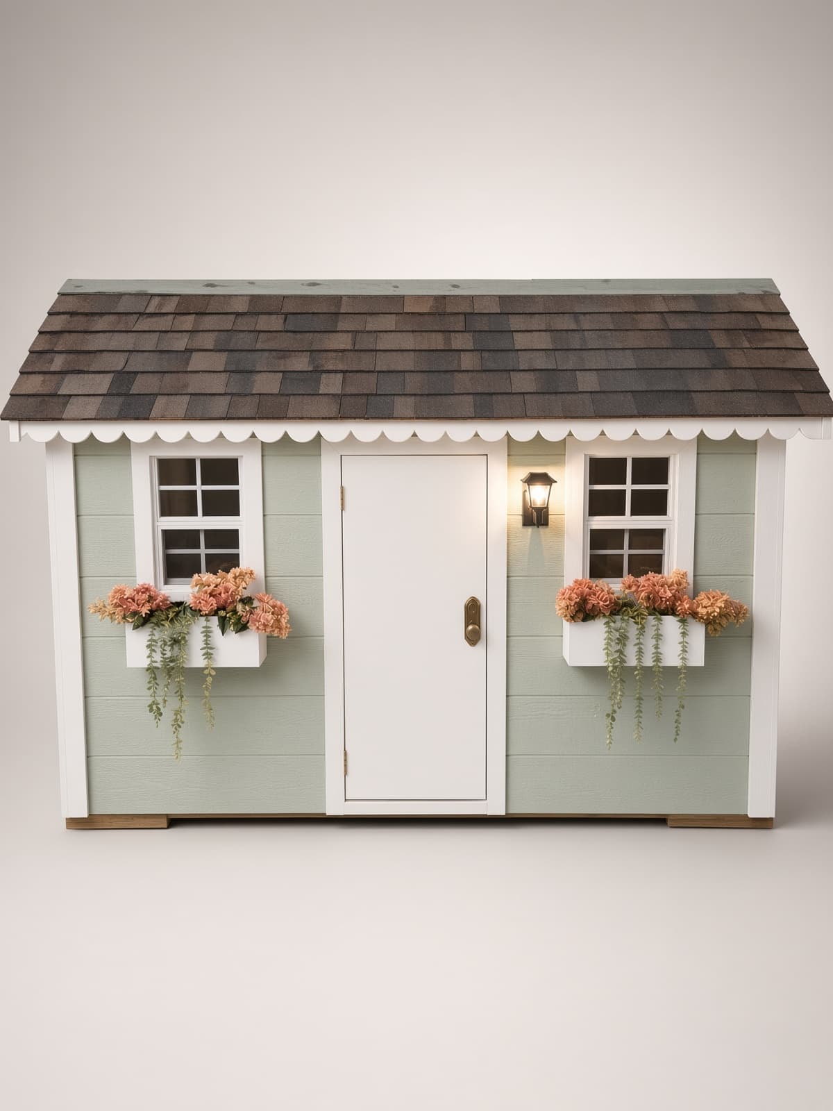 Front view of a Little Dream House with white door, sconce, and coral flower boxes